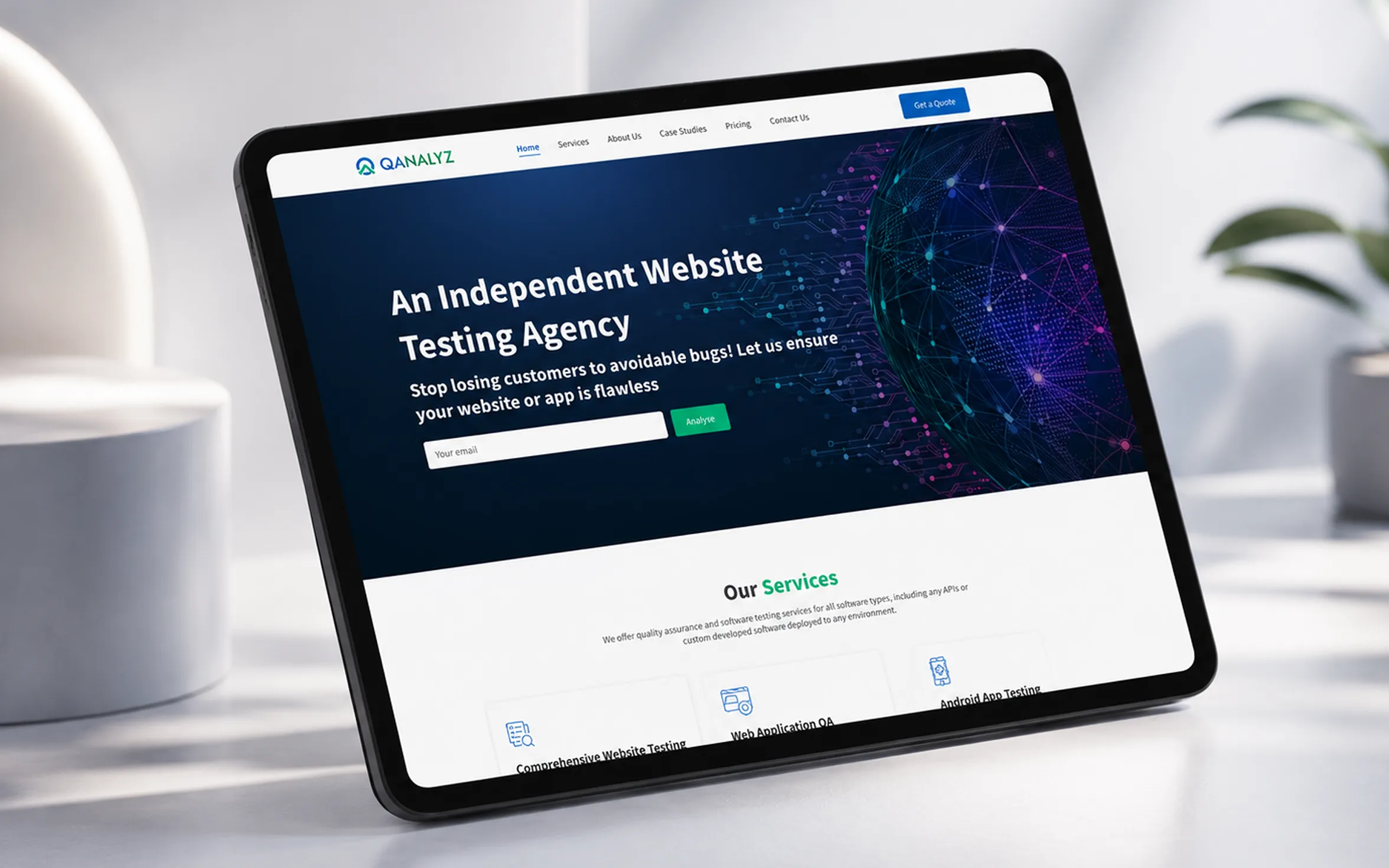 QAnalyz software testing agency website displayed on a tablet, featuring website QA, web application testing, and Android app testing services.